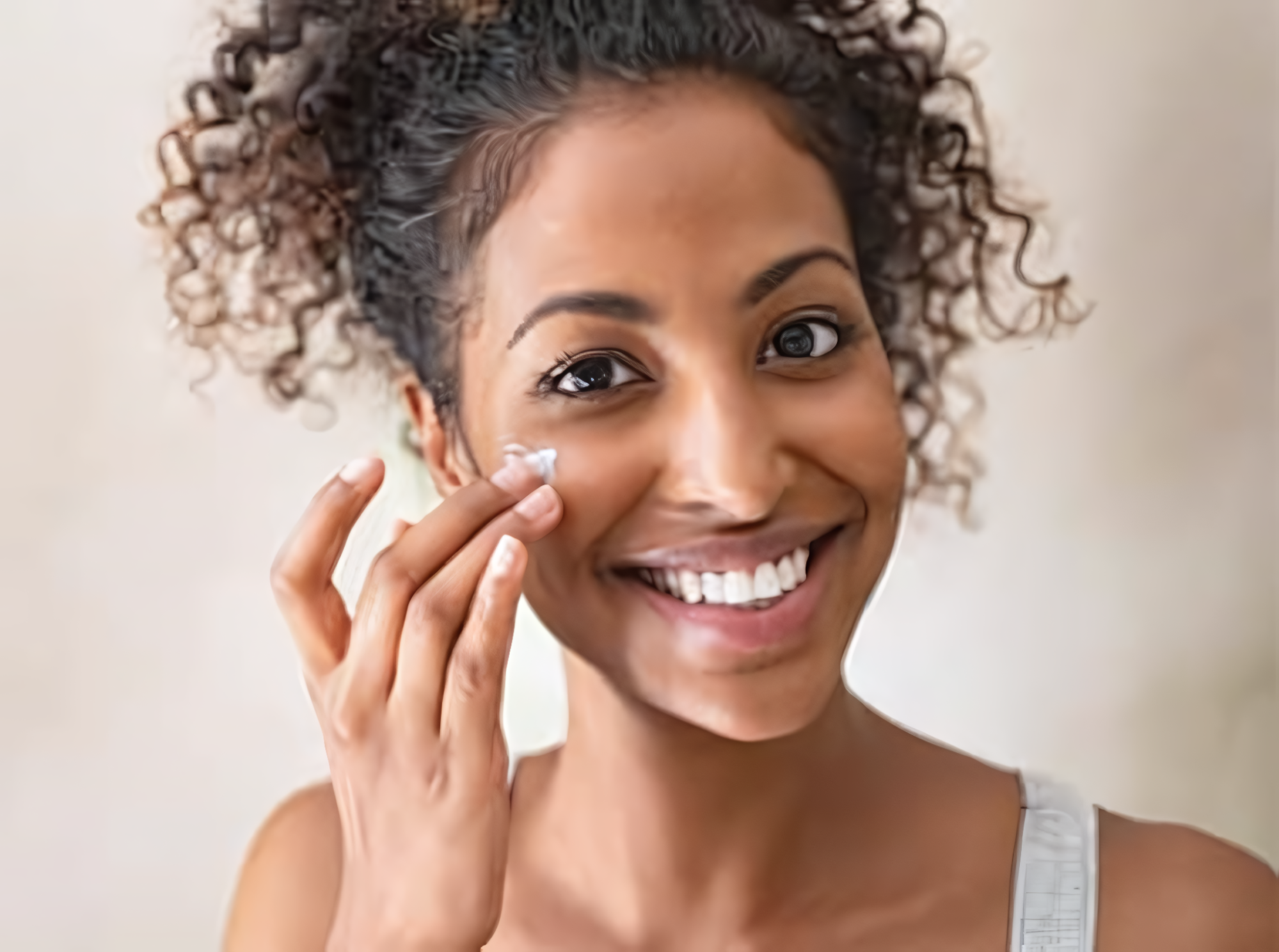 woman applying moisturizer